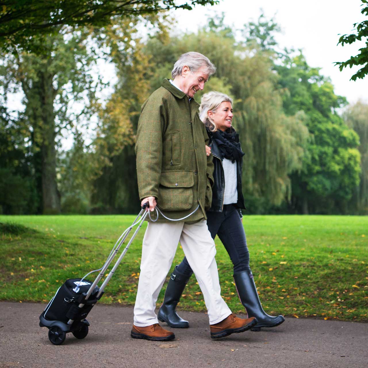 Zen-O Portable Oxygen Concentrator with trolley - Patient walking outdoors